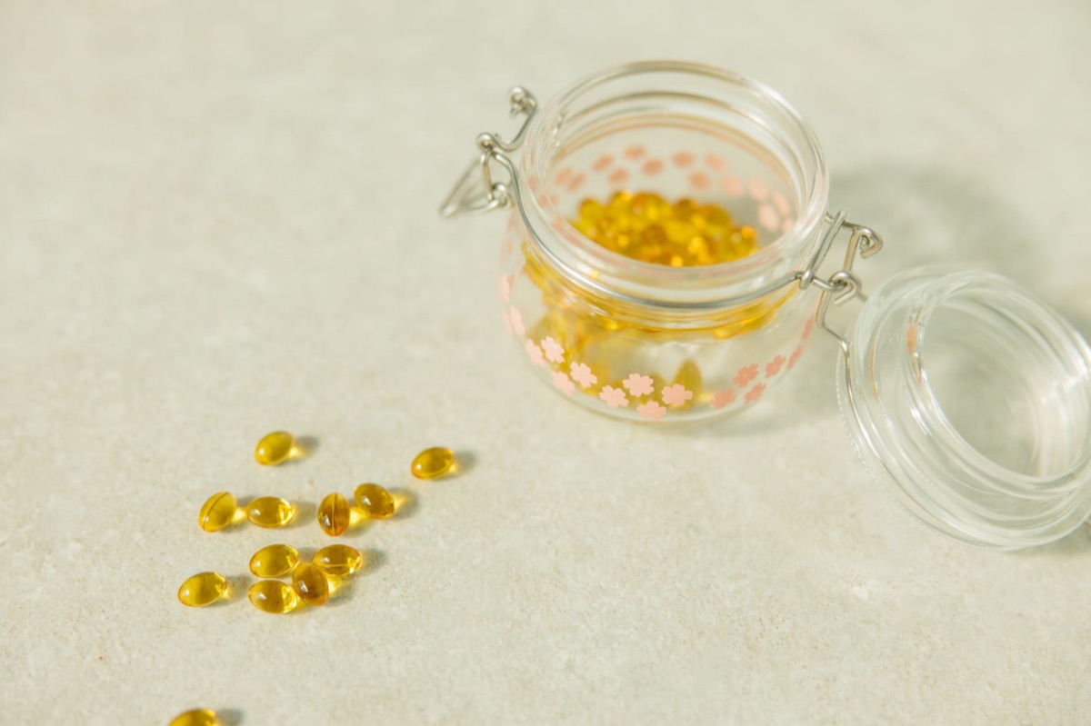 Vitamin D supplement bottle on white background