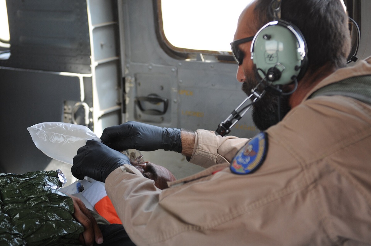 Patient with oxygen mask in hospital room