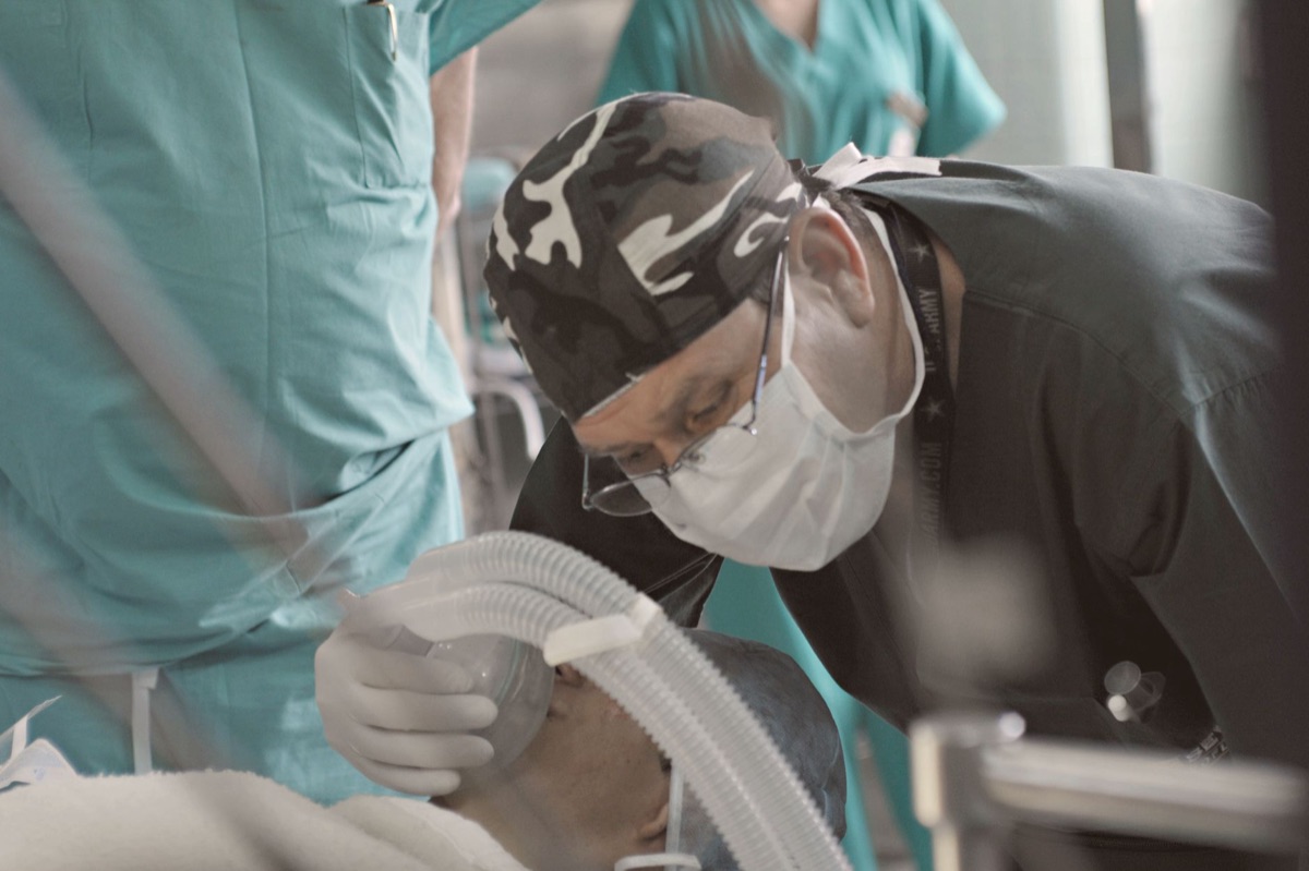 patient wearing oxygen mask for breathing assistance