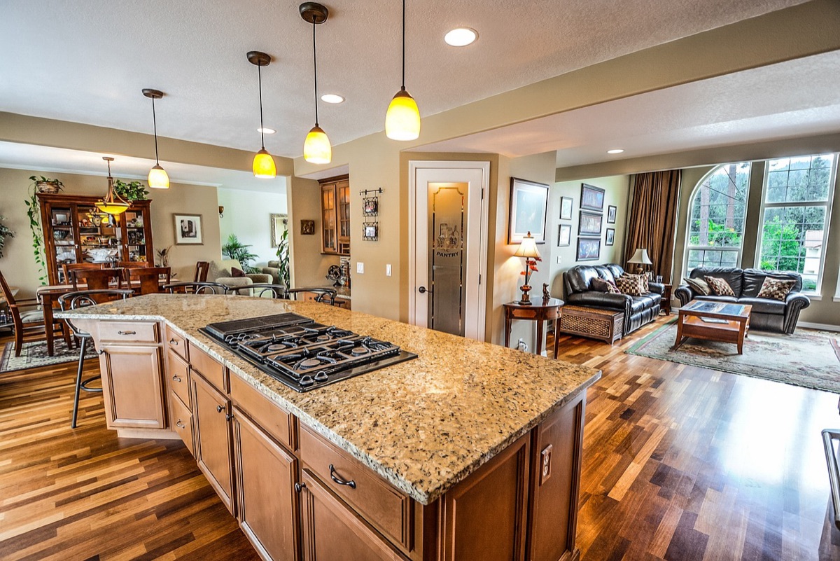 Clean kitchen with white counter, fridge, and sink
