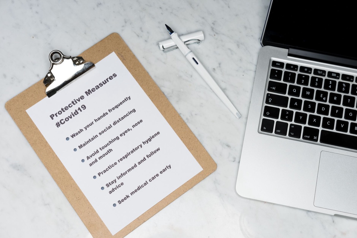 A printed medical checklist with a pen resting on a wooden table.